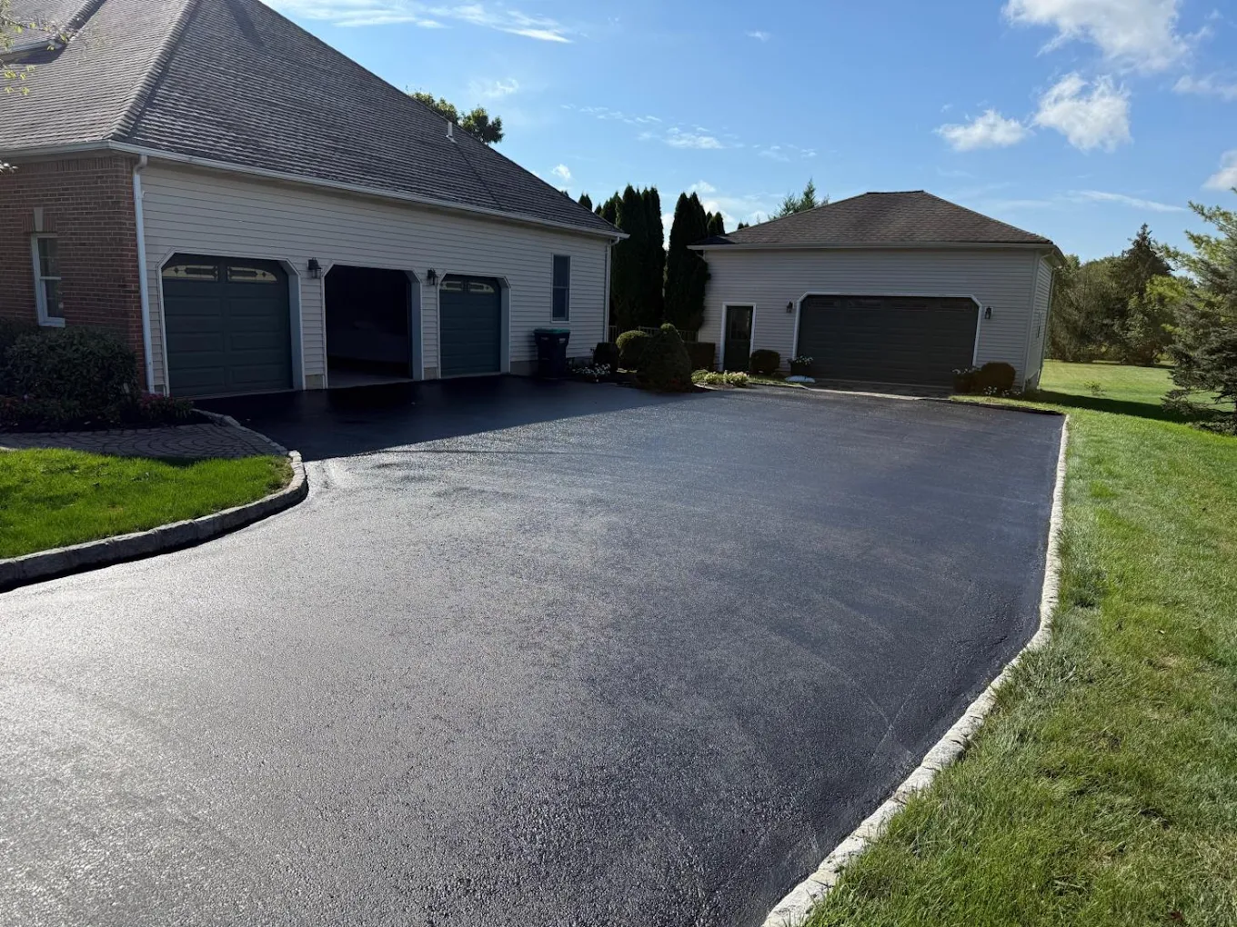 Freshly sealcoated jet-black asphalt driveway in Phillipsburg, NJ